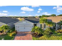 Charming single-story home with a two-car garage, beautiful landscaping, and a brick paved driveway at 14444 59Th E Cir, Bradenton, FL 34211
