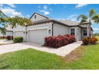 Beautiful single-story home with a well-maintained lawn, paver driveway, and tidy landscaping at 17885 Cherished Loop, Bradenton, FL 34211