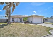 Charming single-story home with a well-maintained lawn and attached two-car garage, inviting curb appeal at 1789 Elm Dr, Venice, FL 34293