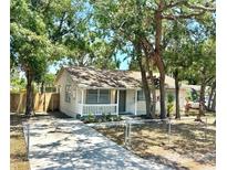 Charming single-story home with a front porch, inviting curb appeal, and beautiful trees at 2721 7Th W St, Bradenton, FL 34205