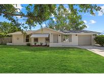 Charming single-story home with a well-manicured lawn and a quaint, inviting facade at 3301 62Nd Street W Cir, Bradenton, FL 34209