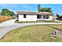 View of single-story home, with a large driveway and front lawn needing landscaping at 4221 26Th W St, Bradenton, FL 34205