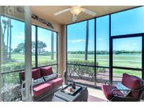 Relaxing screened lanai featuring comfortable seating and a serene view of the golf course at 8205 Grand Estuary Trl # 101, Bradenton, FL 34212