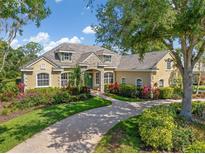 Charming home featuring manicured landscaping and a welcoming brick driveway at 8838 Bloomfield Blvd, Sarasota, FL 34238