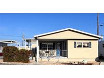 Charming single-story home with a cozy porch, featuring blue accents, neutral siding, and manicured landscaping at 112 Park Ter, Venice, FL 34285