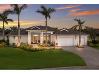 Charming home featuring a manicured lawn, lush landscaping, and a three-car garage at 14210 9Th Ne Ter, Bradenton, FL 34212