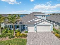 Beautiful two-story home with a three-car garage, lovely landscaping, and waterfront views at 16148 Preservation Blvd, Punta Gorda, FL 33982