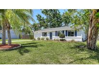 Charming single story home featuring a lush green lawn and a well maintained landscape at 2959 N Lockwood Meadows Blvd, Sarasota, FL 34234