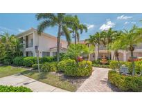 Inviting condo exterior with lush landscaping, a water fountain, and well-maintained walkways at 4264 Central Sarasota Pkwy # 111, Sarasota, FL 34238