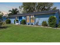 Charming blue single-story home with well-manicured lawn and inviting front entrance at 4403 5Th W Ave, Palmetto, FL 34221