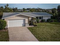 Charming single-story home featuring a well-maintained lawn, and a two car garage at 512 Shamrock Blvd, Venice, FL 34293