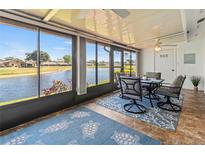 Bright sunroom features a waterfront view and stylish dining set, creating a serene and inviting space at 6218 29Th W Ave # 6218, Bradenton, FL 34209