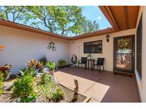 Charming courtyard with garden, table, chairs, and decorative turtle art creating a tranquil outdoor living space at 6304 Pelican Dr, Bradenton, FL 34210