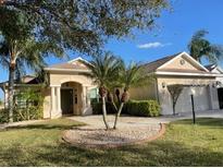 Charming single-story home with manicured lawn, palm trees, and inviting curb appeal in a sunny locale at 6415 67Th E St, Bradenton, FL 34203