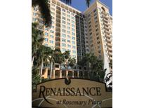 Renaissance at Rosemary Place building exterior featuring lush landscaping and a water fountain at 750 N Tamiami Trl # 208, Sarasota, FL 34236