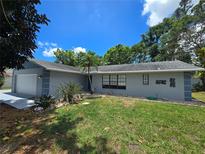 Well-maintained single-story home with a lush green lawn and mature landscaping at 2204 34Th W St, Bradenton, FL 34205