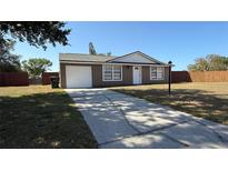 Charming exterior of home with attached garage and well-maintained yard at 2231 Lockwood Meadows Way, Sarasota, FL 34234