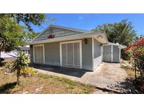 Cozy home featuring light gray siding, complemented by the lush greenery of the surrounding yard at 2448 45Th S St, St Petersburg, FL 33711