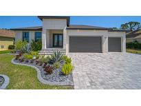 Beautiful single-story home with gray brick driveway and modern landscaping at 260 Marker Rd, Rotonda West, FL 33947
