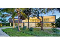 Stunning modern home with lush landscaping, ample parking and striking architectural details at 4123 Bay Shore Rd, Sarasota, FL 34234
