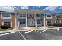 Brick exterior featuring white columns and ample parking at 4158 Tamiami Trl # V1, Port Charlotte, FL 33952