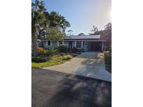Charming single-story home with a well-maintained lawn and a welcoming covered entrance at 4700 Neptune Rd, Venice, FL 34293