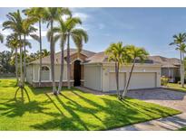 Charming single-story home featuring lush landscaping, stone accents, and a spacious two-car garage at 6520 38Th E Ln, Sarasota, FL 34243
