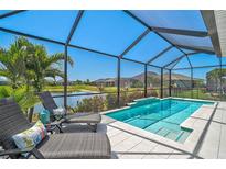 Relaxing screened-in pool overlooking a serene lake, perfect for outdoor enjoyment and waterfront views at 11713 Chevelon Ln, Parrish, FL 34219