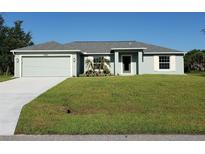 Charming single-story home with a well-manicured lawn and attached two-car garage at 25 Sabot Ct, Placida, FL 33946