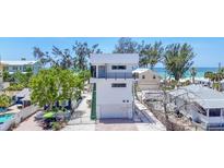 Modern three-story home boasting beach access and parking garage at 2918 Avenue E, Holmes Beach, FL 34217
