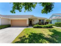 Charming single-story home with a well-manicured lawn and attached two-car garage, exuding curb appeal at 3007 Live Oak Ln, Palmetto, FL 34221