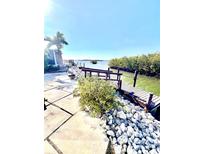 A quaint dock with a charming walkway with views of lush mangroves and tranquil water at 36 N Starboard Dr, Venice, FL 34285
