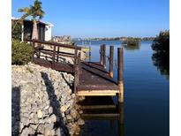 Waterfront property featuring a private boat dock with scenic water views at 36 N Starboard Dr, Venice, FL 34285