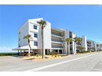 Beautiful three-story condo building with covered parking, tropical landscaping and stunning views at 4800 Gulf Of Mexico Dr # 204, Longboat Key, FL 34228