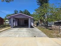 Charming single-story home featuring a carport, concrete driveway, and mature trees at 519 36Th E Ave, Bradenton, FL 34208