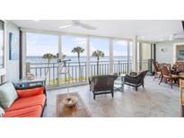 Bright living room featuring floor to ceiling windows with ocean views and access to the balcony at 6470 Mourning Dove Dr # 201, Bradenton, FL 34210