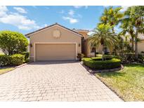 Charming home featuring a two-car garage, brick driveway, and well-maintained landscaping at 6519 43Rd E Ct, Sarasota, FL 34243