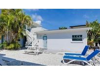 Charming exterior features beach access, outdoor seating and two lounge chairs, perfect for relaxing at 6610 Midnight Pass Rd # 11, Sarasota, FL 34242
