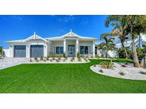 Beautiful home with a manicured lawn and tropical landscaping at 8001 20Th W Pl, Bradenton, FL 34209