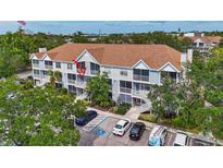 Condo exterior with balconies, parking, and lush greenery around the building at 850 S Tamiami Trl # 624, Sarasota, FL 34236