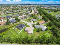 A beautiful aerial view of this single-Gathering home with a screened-in pool, lush landscaping, and serene water features at 9106 Yarberry St, Sarasota, FL 34240