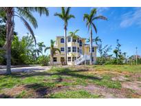 Stunning multi-level home with ample windows, white stairs, and surrounded by lush tropical landscaping at 9315 9Th Nw Ave, Bradenton, FL 34209