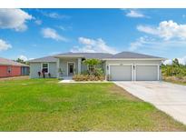Charming single Gathering home featuring a well manicured lawn and a two car garage at 9601 Calumet Blvd, Port Charlotte, FL 33981