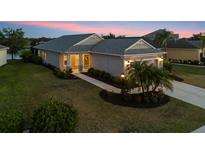 Charming single-story home with well-manicured lawn and inviting walkway leading to the front door at 12237 Longview Lake Cir, Bradenton, FL 34211