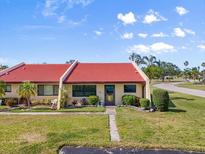 Charming single-story home with a red tile roof, well-maintained lawn, and meticulous landscaping at 1302 58Th W St, Bradenton, FL 34209
