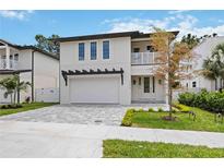 Beautiful two-story home featuring a two-car garage, balcony, and manicured lawn at 2590 Floyd St, Sarasota, FL 34239