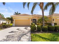 Charming single-story home with a well-manicured lawn, mature landscaping, and a two-car garage at 27243 Ipswich Dr, Englewood, FL 34223
