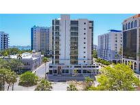 Modern, white high-rise condo building featuring balconies and floor-to-ceiling windows at 300 S Pineapple Ave # 302, Sarasota, FL 34236