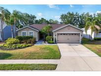 Charming single-story home with a manicured lawn, two-car garage and mature landscaping at 4211 Kingsfield Dr, Parrish, FL 34219