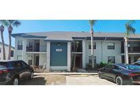 Two story condo building with palm trees and parking in front at 4415 45Th W Ave # 203, Bradenton, FL 34210